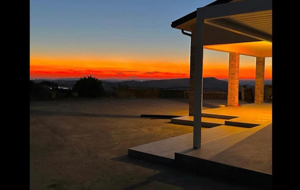 a sunset with a view of the mountains at Domus del Gotha in Mazzarino
