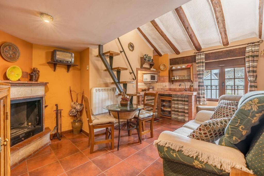 a living room filled with furniture and a fireplace at Tomillo in Hinojares