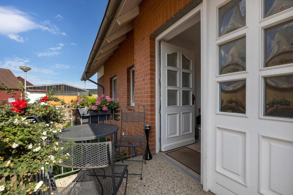 a door leading to a patio with a table and chairs at Veith in Hildesheim