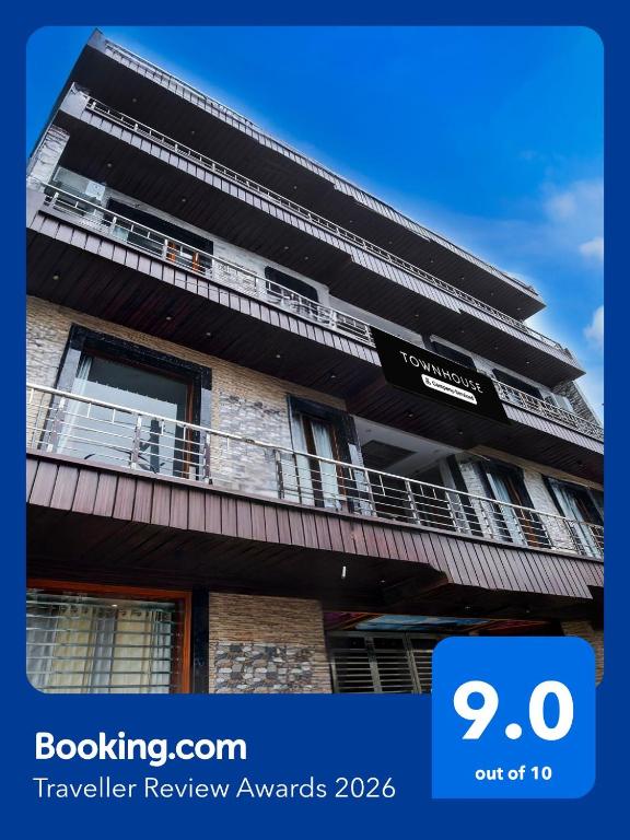 a building with a balcony and a sign on it at Super Townhouse by OYO Chandigarh Near PEC-PGI-PU Formerly Hotel Paradise in Chandīgarh