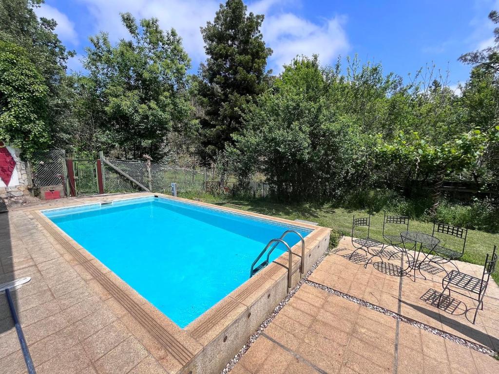 a large swimming pool in a yard at Quinta das Cavadas in Canedo