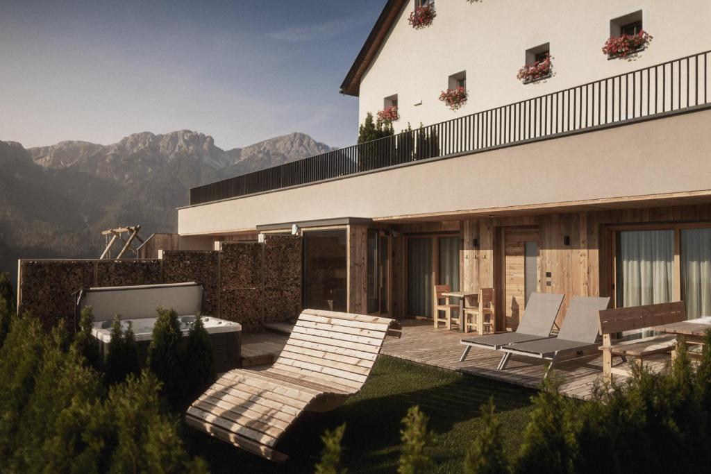 a house with a patio with a view of mountains at Rueper Hof Chalet Pracken in Valdaora