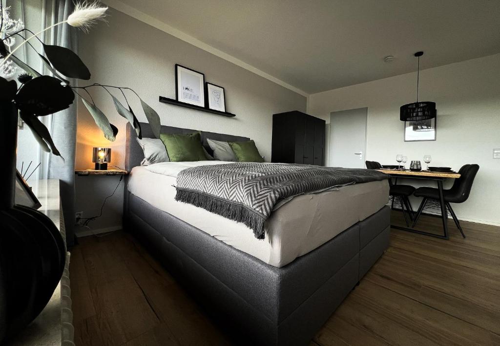 a bedroom with a bed and a desk in it at Black Forest Home in Schönwald