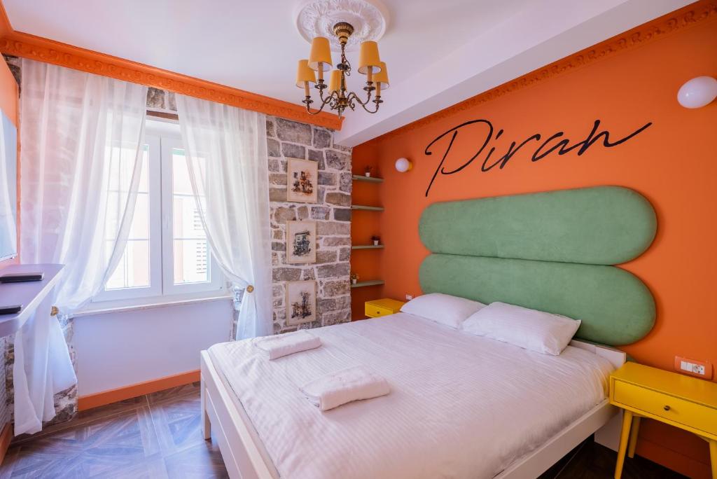 a bedroom with a bed with a sign on the wall at Casa Libertà Suites & Studios Piran in Piran