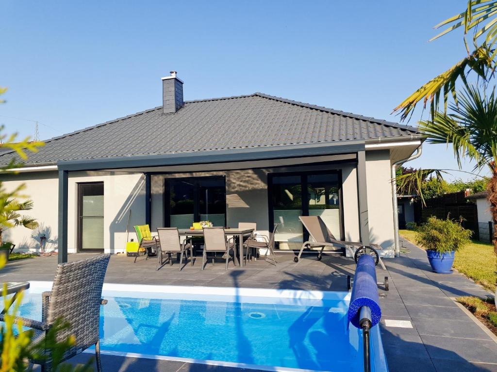 a house with a swimming pool in front of a house at Ferien Marx in Oberbrechen
