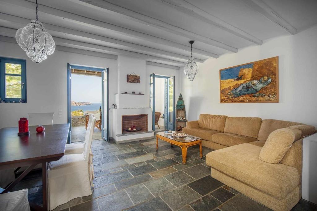 a living room with a couch and a table at Almira in Livadi