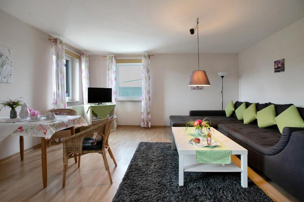 a living room with a couch and a table at Ferienwohnung Postel in Meldorf