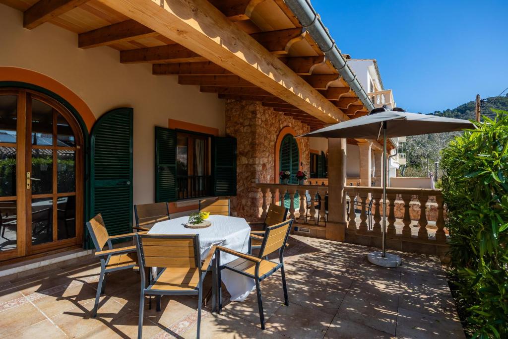 a patio with a table and chairs and an umbrella at Sa Torre I in Canyamel