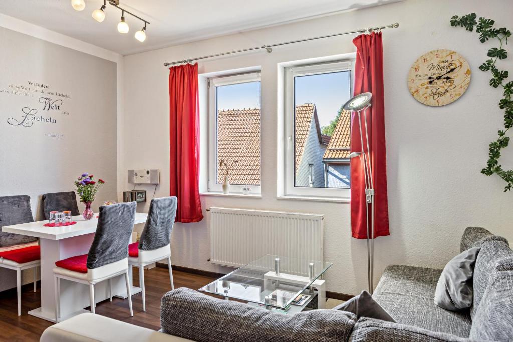 a living room with a couch and a table at Ferienwohnung Thüringer Wald in Ilmenau