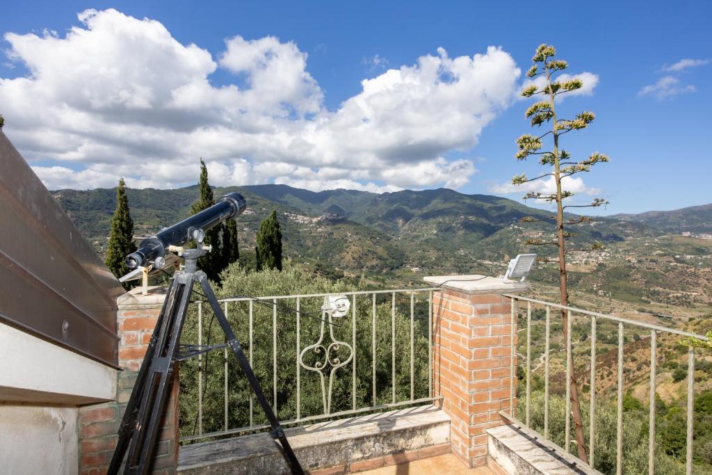 a view from the balcony of a house with a telescope at Bed And Breakfast Sciarammola in Patti