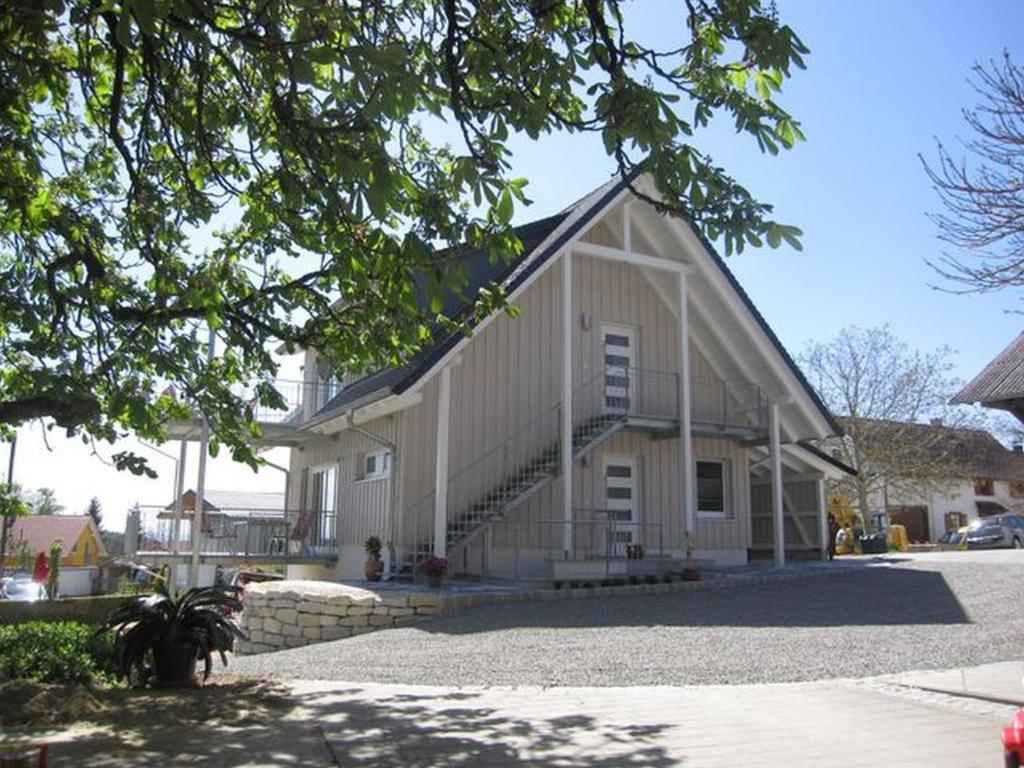 a large white barn with a staircase on it at Apfelhof - Ferienwohnung Wielath in Salem