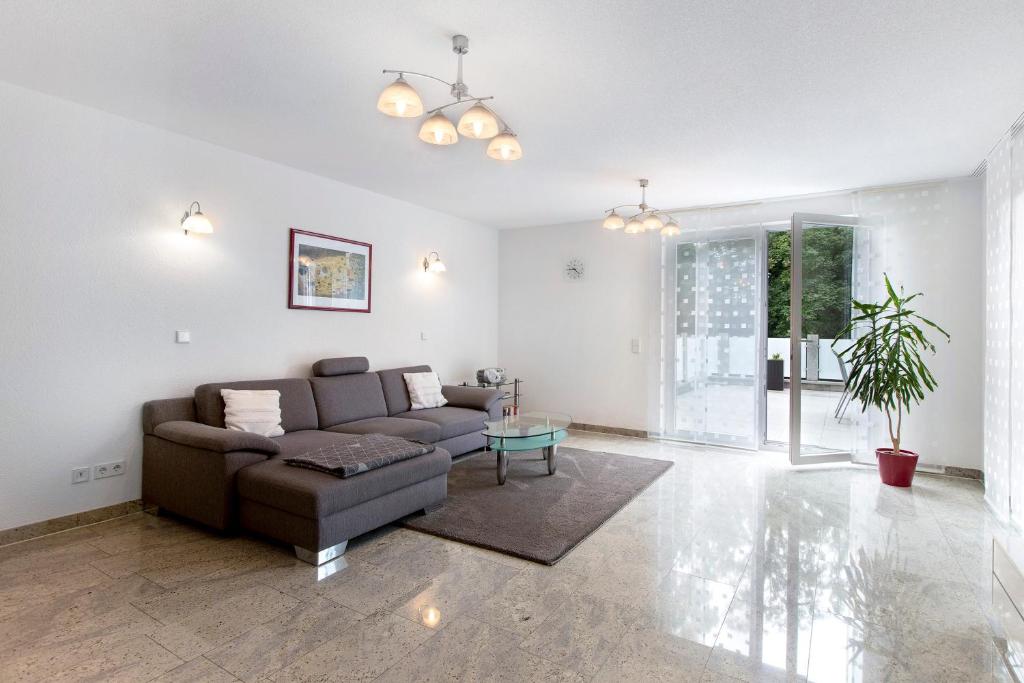 a living room with a couch and a table at Ferienwohnung Milita in Lörrach