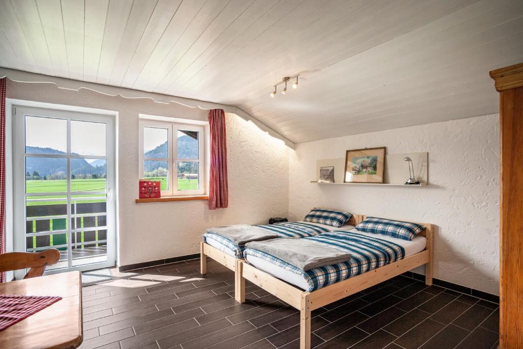 a bedroom with a bed in a room with a window at Appartement Braun 1 in Bolsterlang