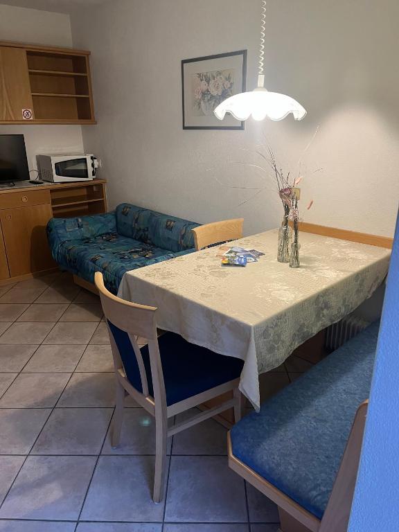 a dining room with a table and a couch at App Sonne Nr 15 in Lutago