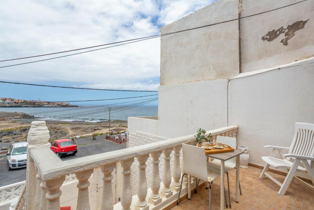 a balcony with a table and chairs and a view at Beach House el Poris 2 in Poris de Abona