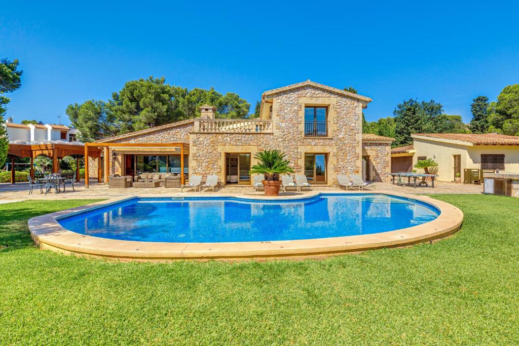 a house with a swimming pool in the yard at Casa Del Pinaret in Port de Pollensa