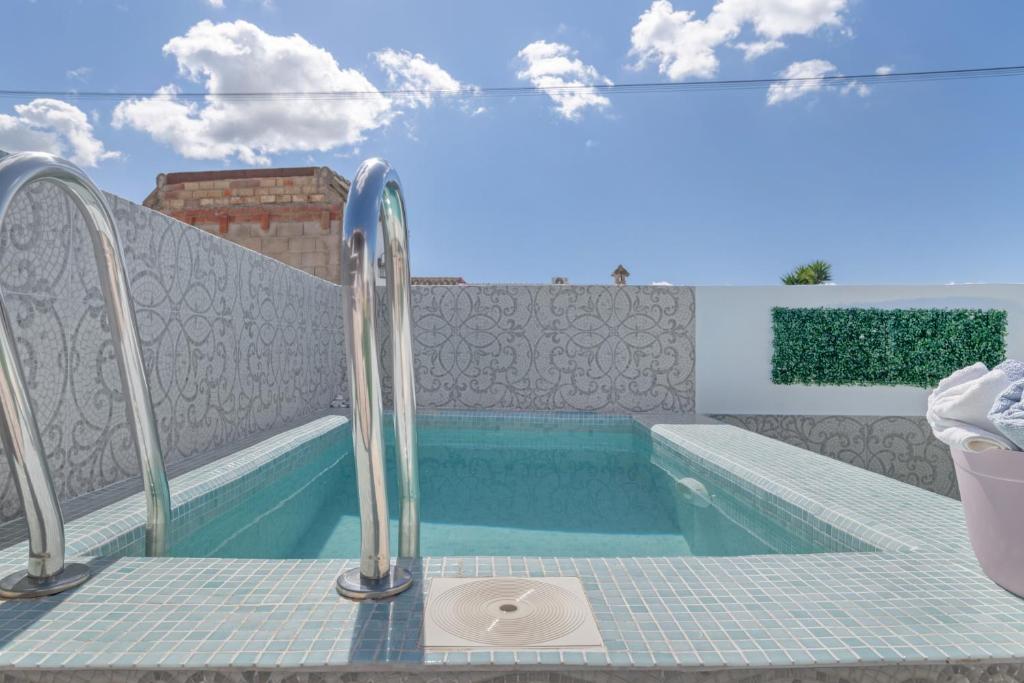 a swimming pool with a hot tub and a swimming pool at Casa Rocio in Barrio Nuevo