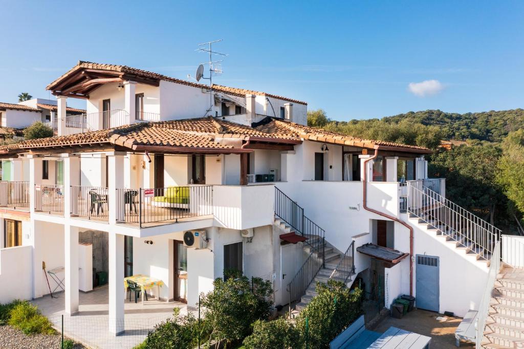 a white building with stairs in front of it at Pasquale Home Holiday in Bari Sardo