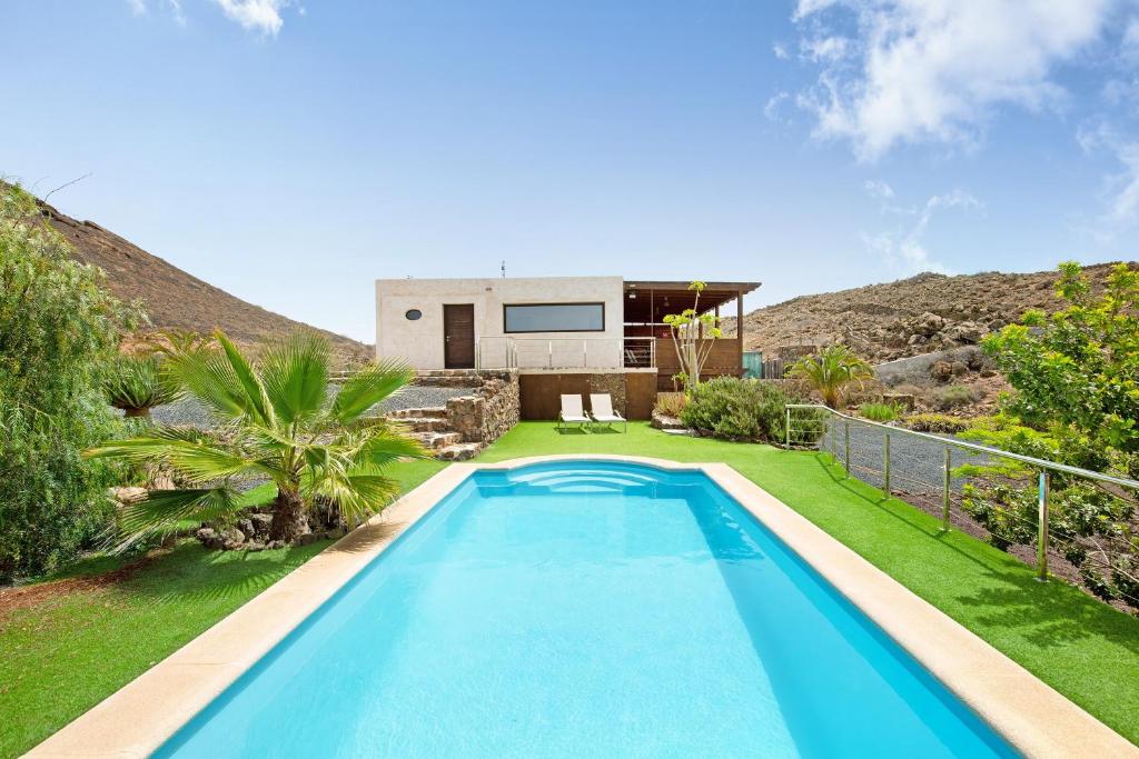 a swimming pool in the backyard of a house at Tayu Eco Villa in Villaverde