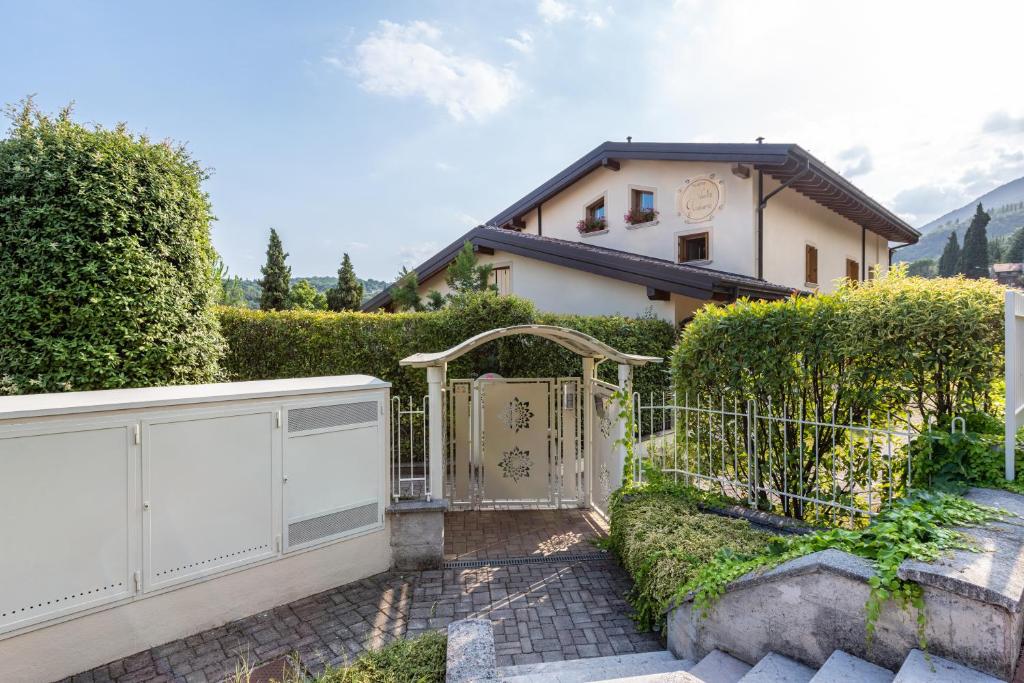 a white gate in front of a house at Kastel's house in Roe