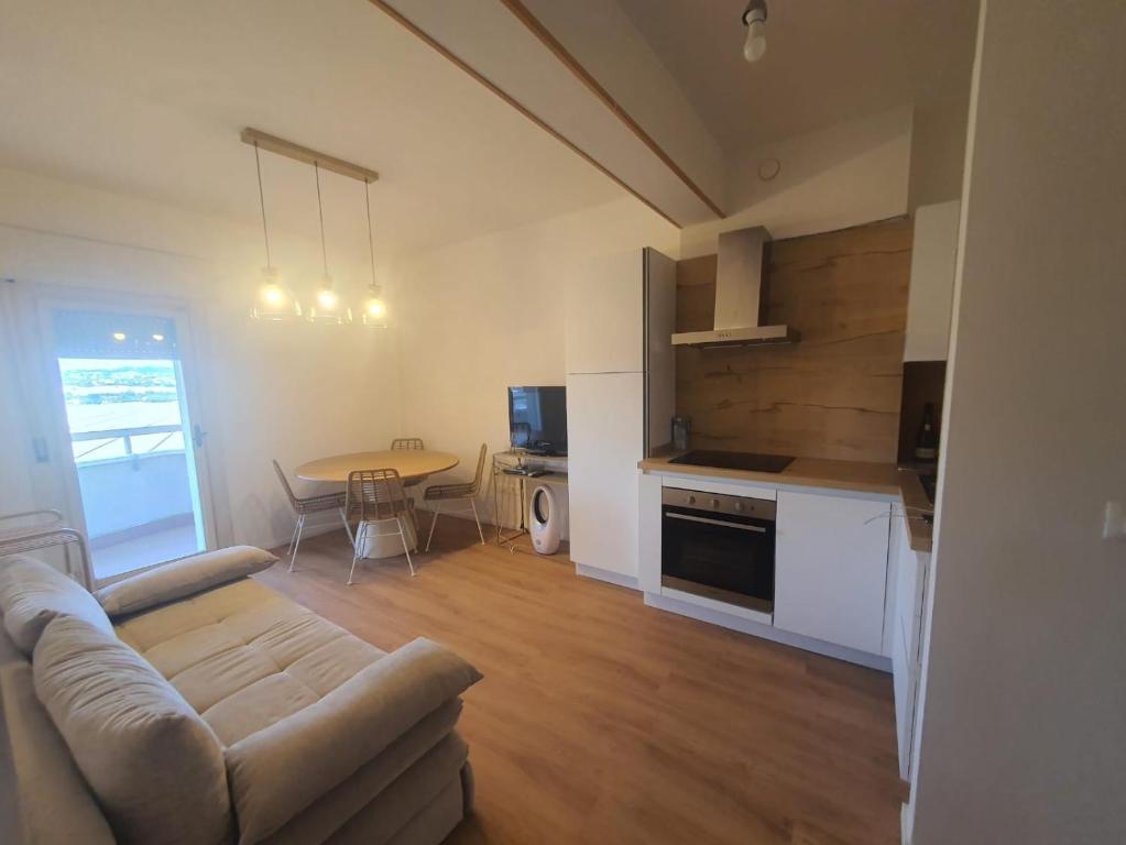 a living room with a couch and a table at Civico 316 con Piscina in Porto Recanati