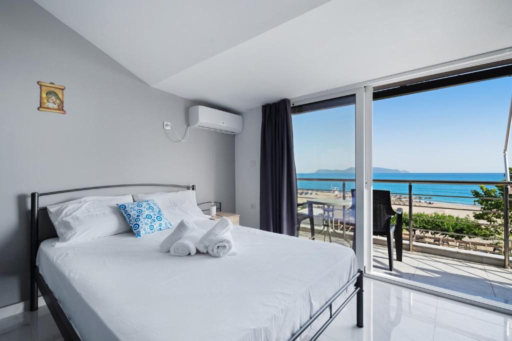 a bedroom with a bed with a view of the ocean at Iguana studio 18 in Preveza