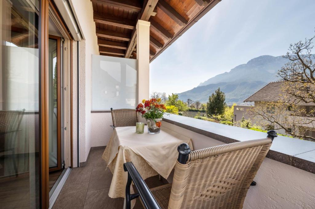 a table on the balcony of a house at Haus Rosengarten Apt B in Terlano