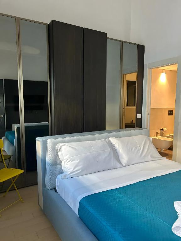 a bedroom with a large bed with blue and white sheets at Luxury Room in Bari