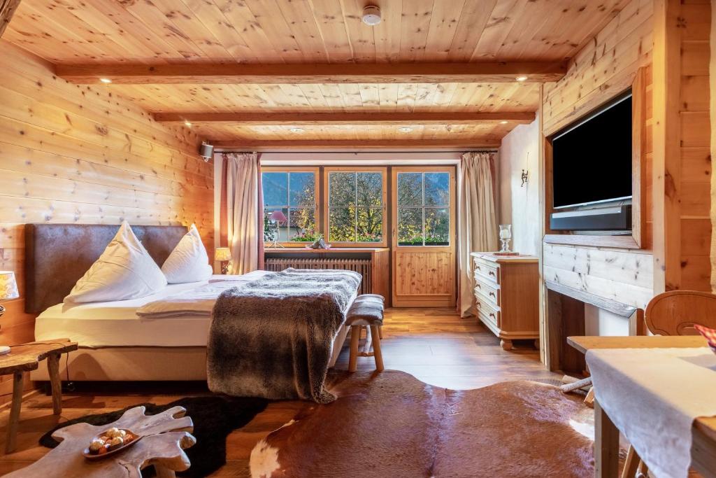 a bedroom with a bed and a large window at Chalet Alpenherz in Inzell