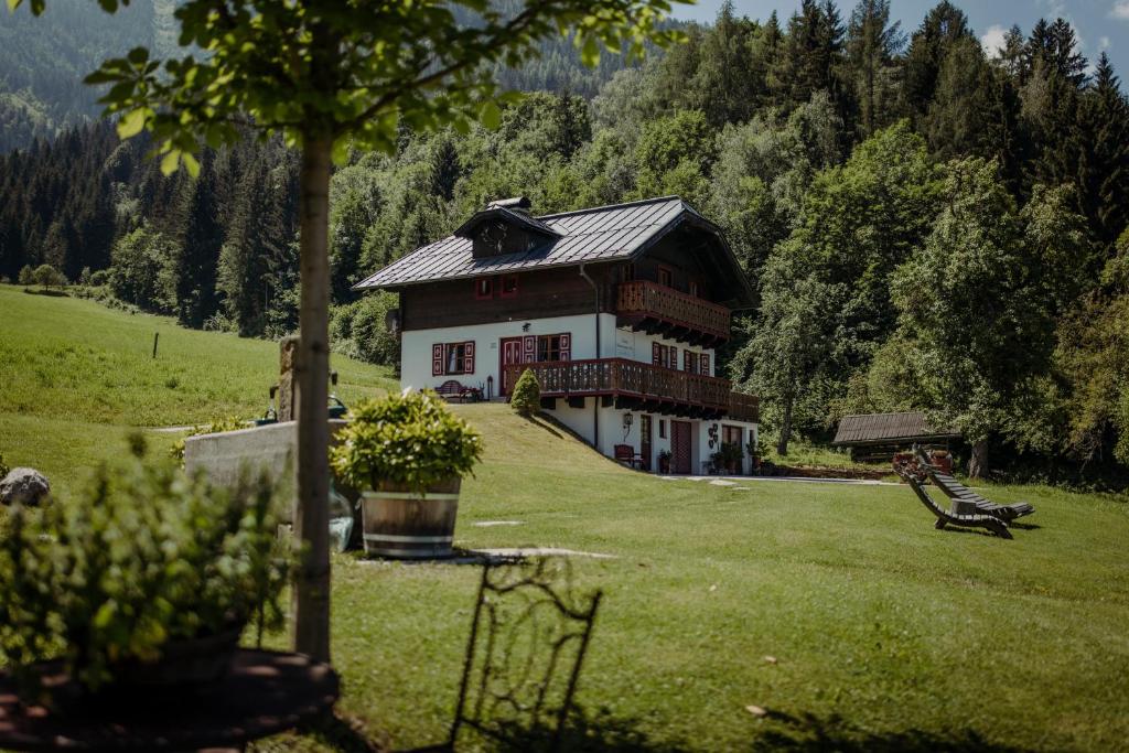 a large house on a green field with trees at Chalet Hinterweiding Gut in Wiederriesen