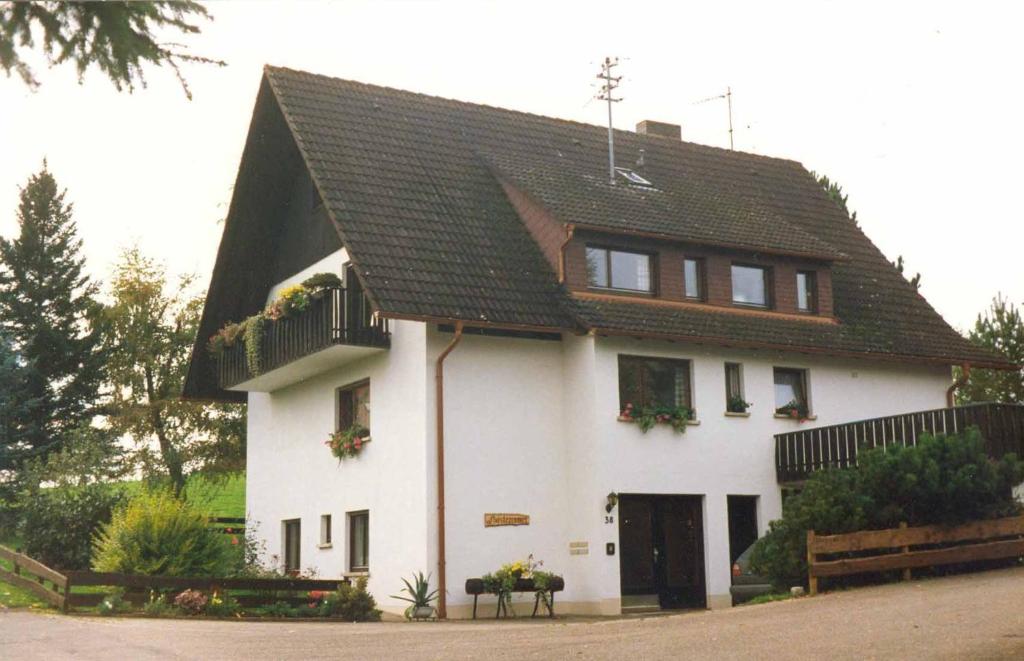 a large white house with a black roof at Ferienwohnung Blattmann in Sankt Peter