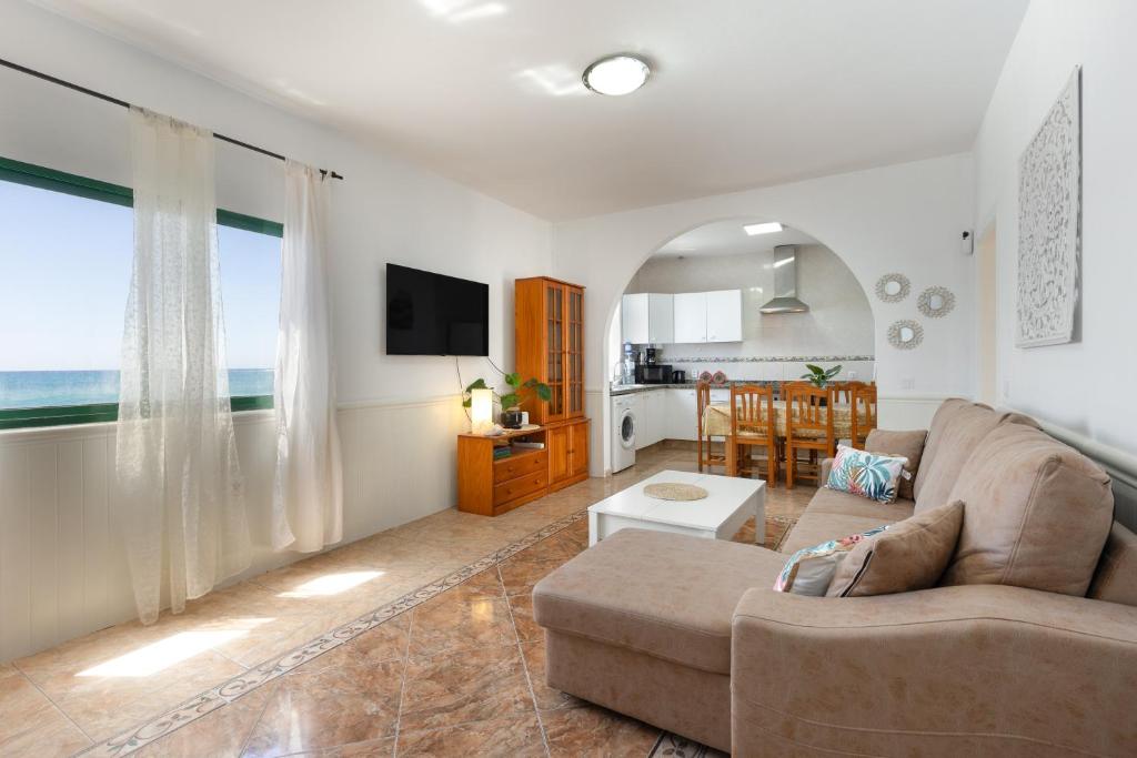 a living room with a couch and a table at Buganvilla in Pájara