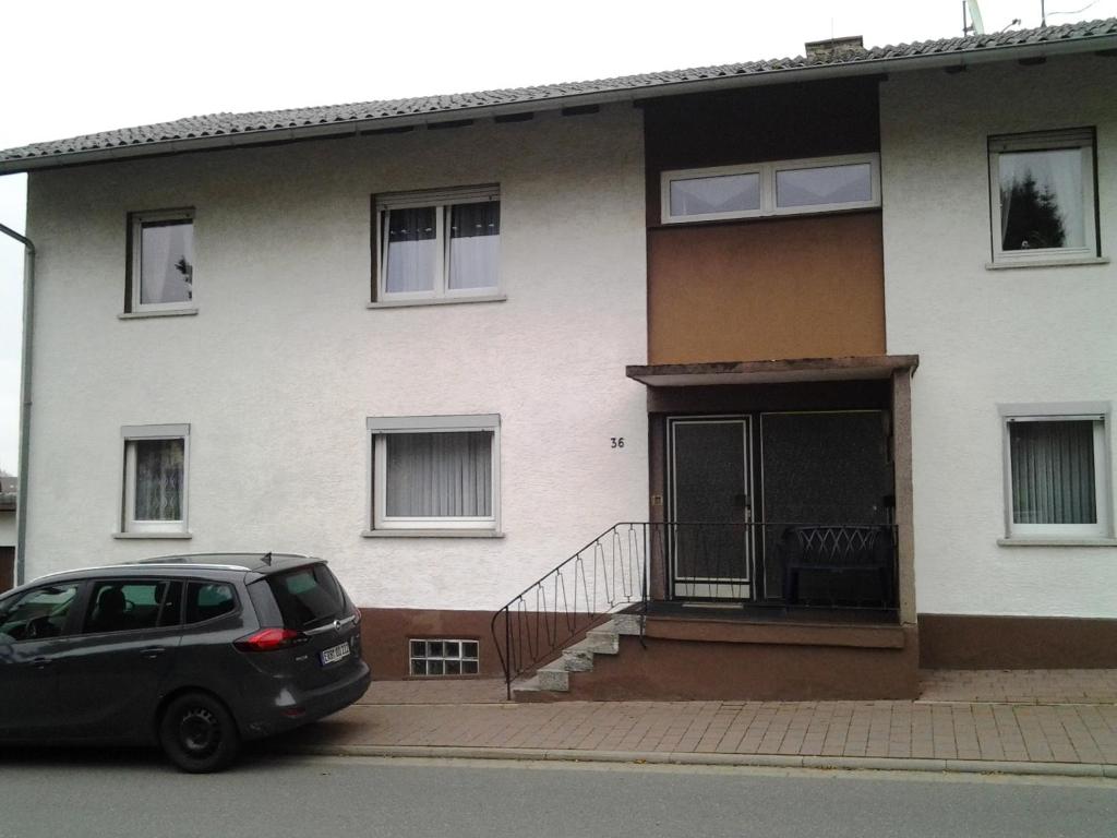 a car parked in front of a house at Ferienwohnungen Harling in Erbach im Odenwald