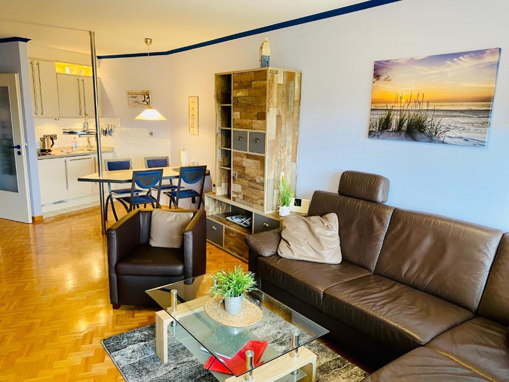 a living room with a couch and a table at 109 im Lord Nelson in Cuxhaven