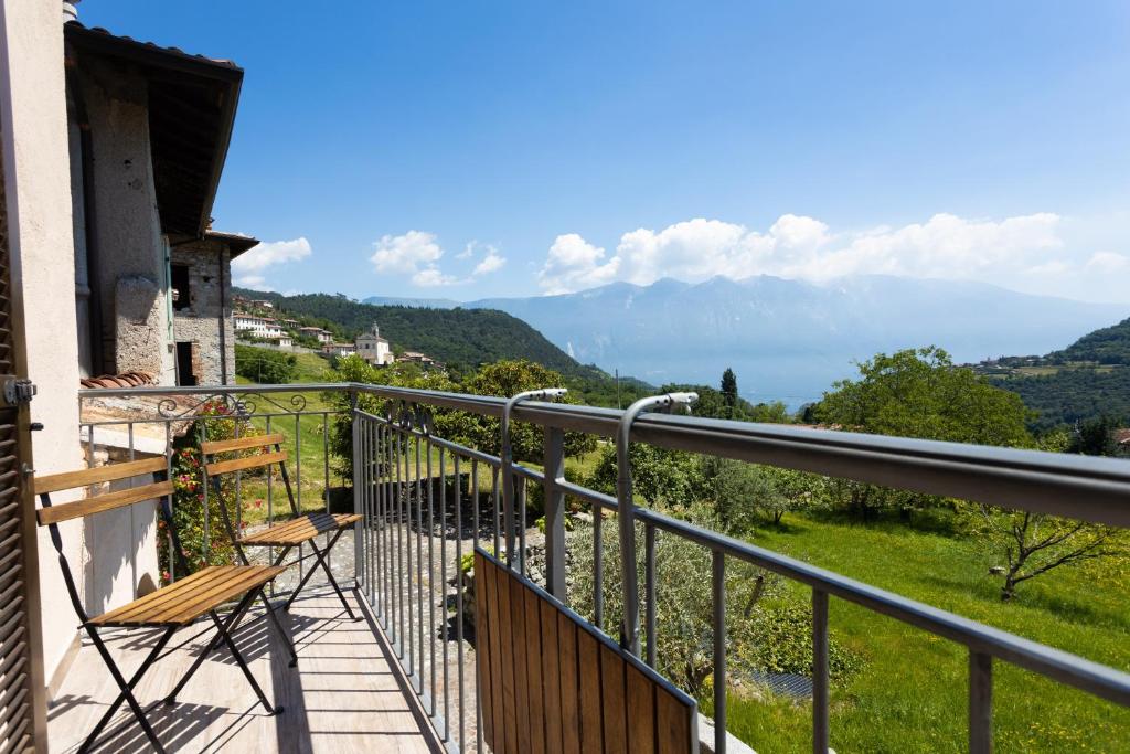 a balcony with a chair and a view of the mountains at Artù in Tremosine Sul Garda