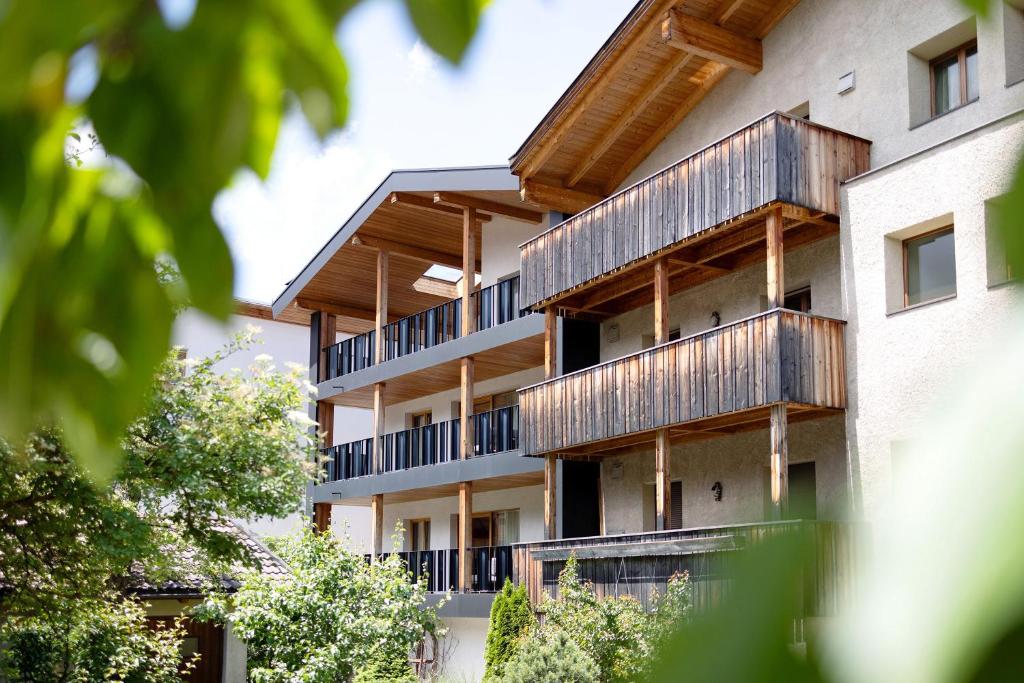 a building with wooden balconies on the side of it at Kriendl Nr 1 in Valdaora