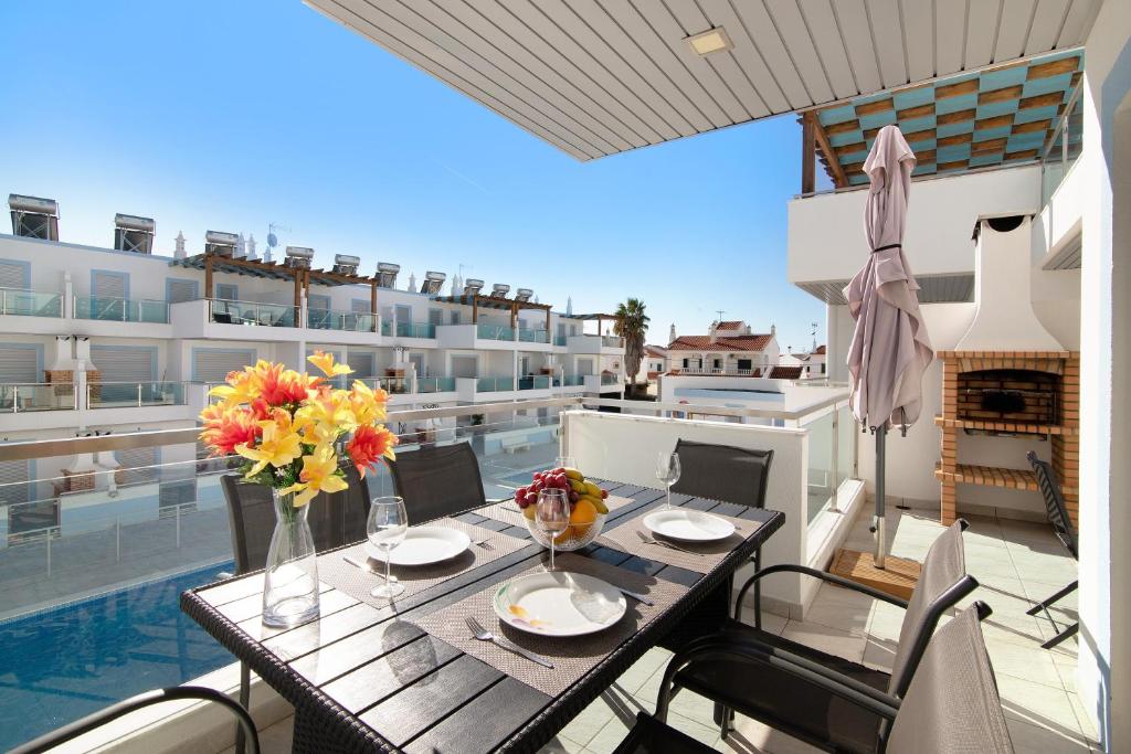 a table with flowers on top of a balcony at Numar Residence Villa X in Manta Rota
