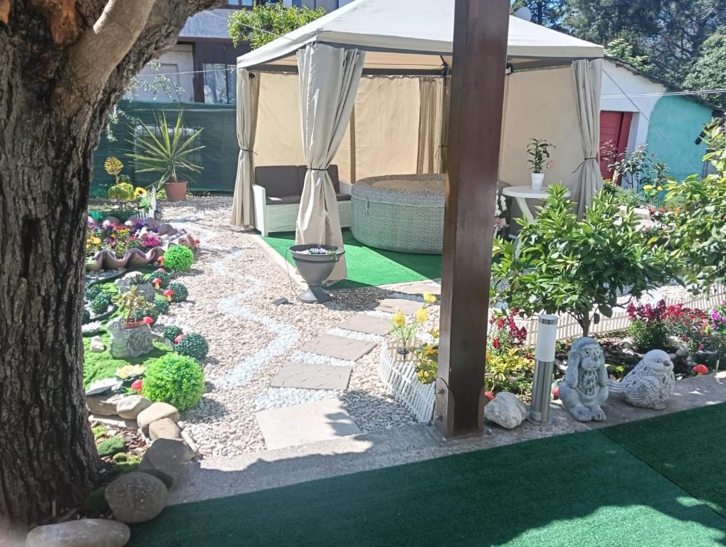 a garden with a white tent and some plants at Il SORRISO in Moie