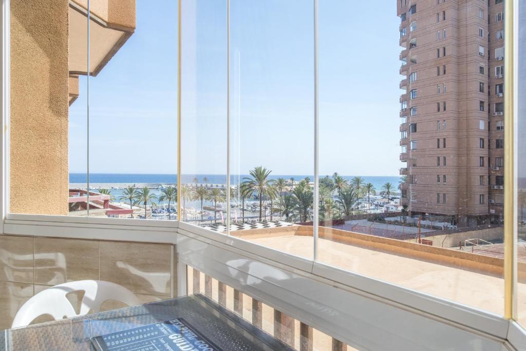 a balcony with a view of the ocean from a building at Marina view sunny apartment in Fuengirola