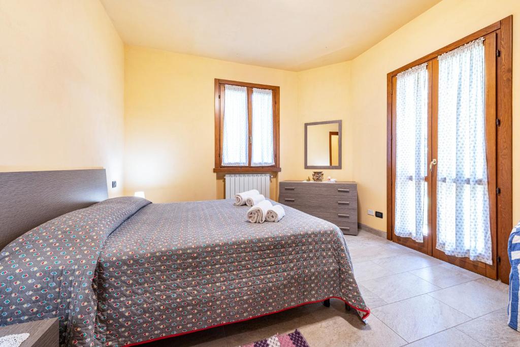 a bedroom with a bed with a dog laying on it at Casa Caterina con giardino in Marone