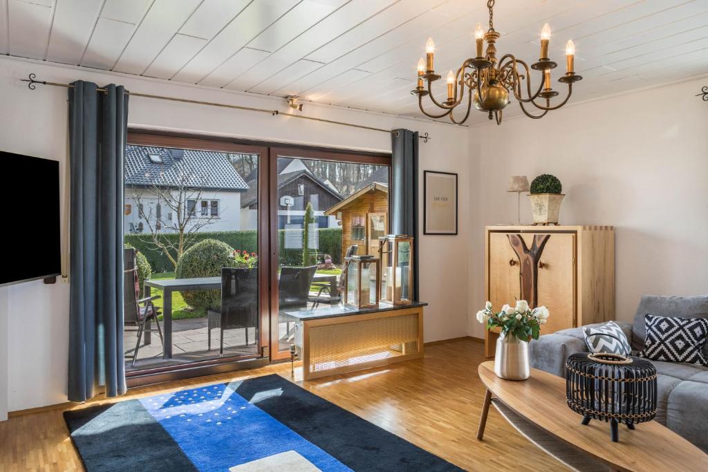 a living room with a couch and a tv at Am Twistesee 2 Ebenerdig in Wetterburg