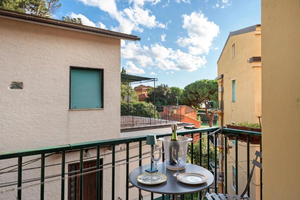 a table with a bottle of wine on a balcony at Apartment Beach next to 5 Terre in Bonassola