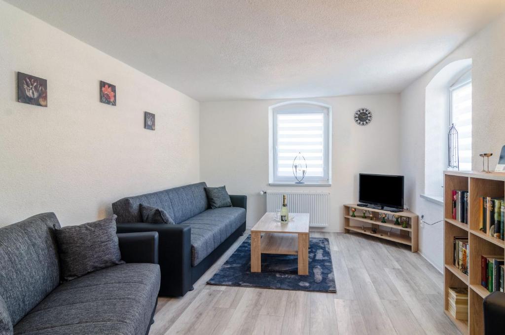 a living room with a couch and a table at Mina in Krauchenwies