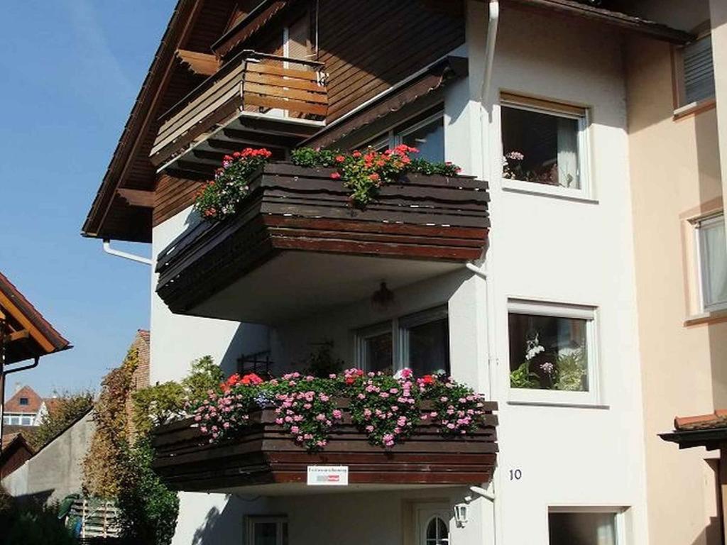 a building with flower boxes on the side of it at Haus Alpenblick in Immenstaad am Bodensee