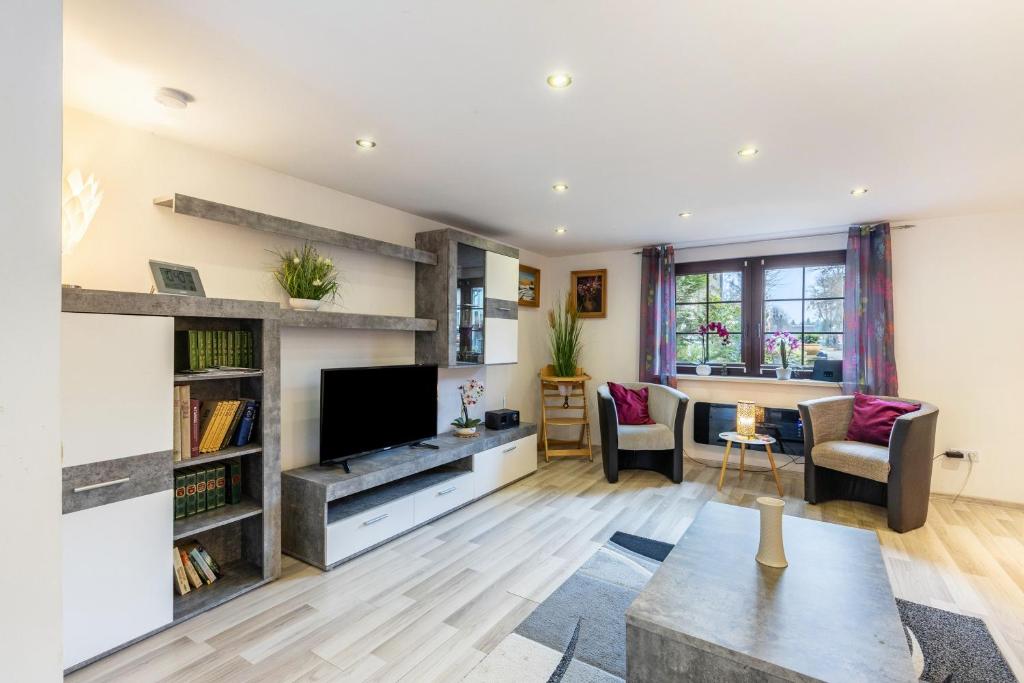 a living room with a tv and a couch at Ferienhaus Am Reiterhof in Templin