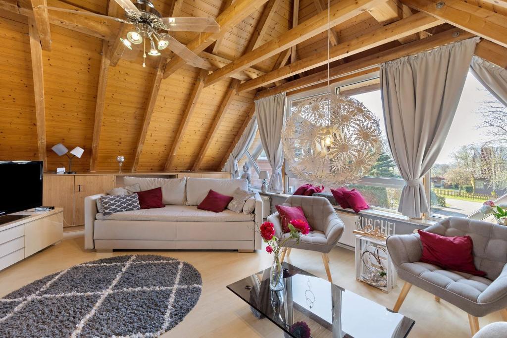 a living room with two couches and a tv at Ferienhaus Harmonie in Südbrookmerland