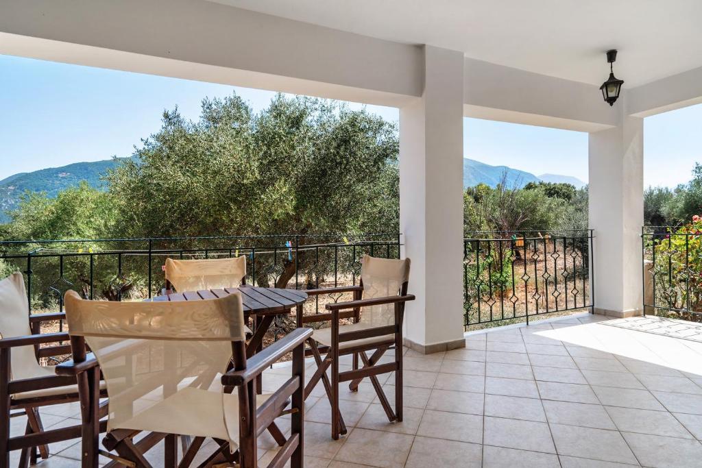 a patio with a table and chairs on a balcony at Daratos apartment 6 in Kefallonia