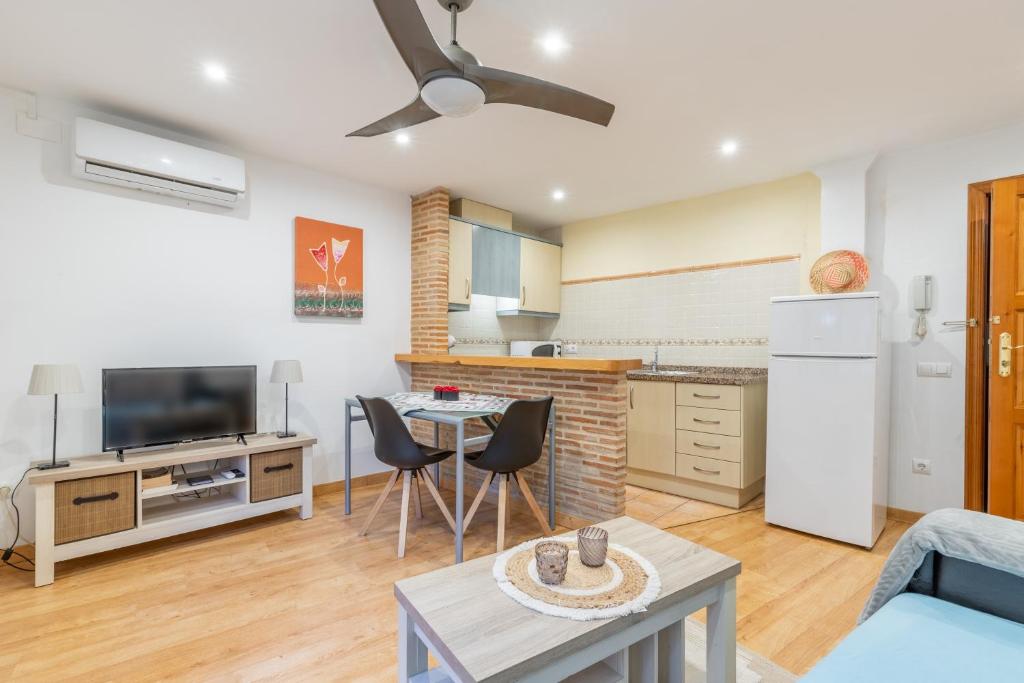a kitchen and living room with a table and chairs at Tosca Mar 223 in Moraira