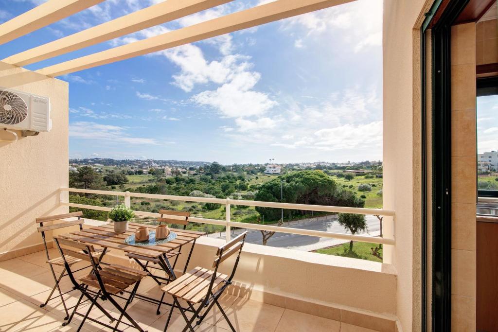 a balcony with a table and chairs and a view at Sunrise Salgados Village in Galé