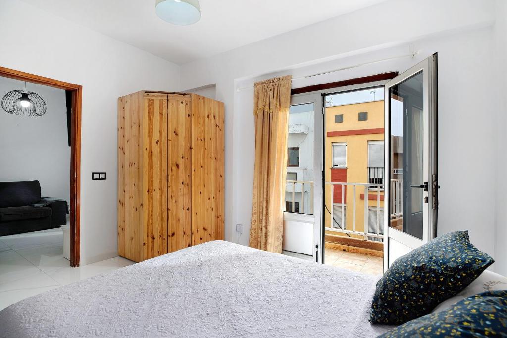 a bedroom with a bed and a large window at Piso Leon y Castillo B in Arrecife